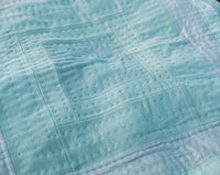 Housetop quilt made from blue reclaimed fabrics. Hand made in Naarm / Melbourne by Britta Rouse